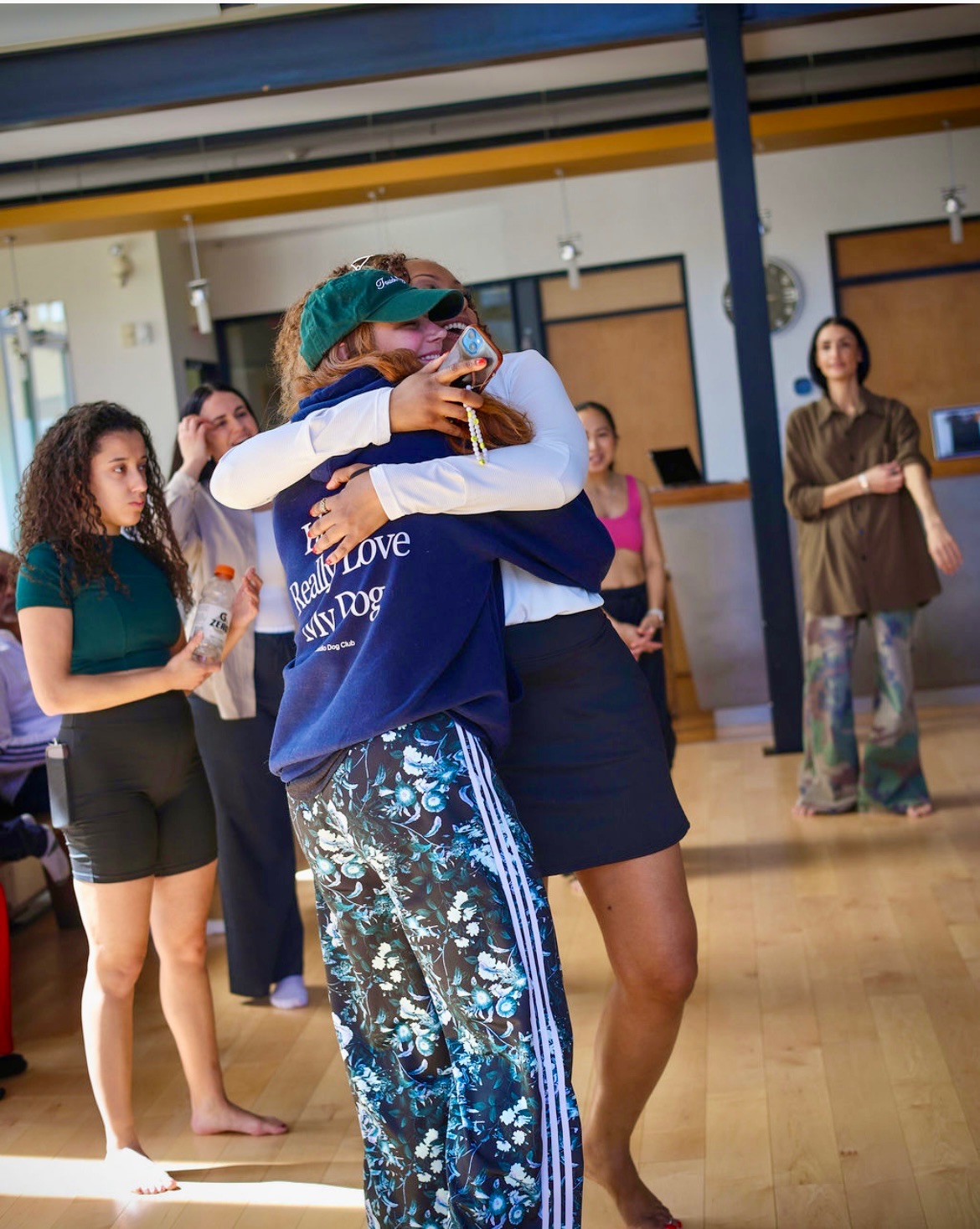 Two sisters embracing in a tight, joyful hug — Day 7 closing of the retreat