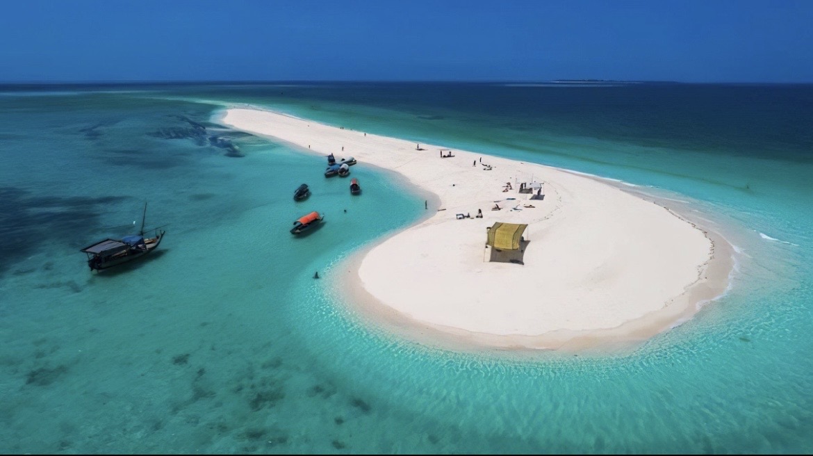 Aerial view of a sandbank surrounded by turquoise Indian Ocean waters near Zanzibar